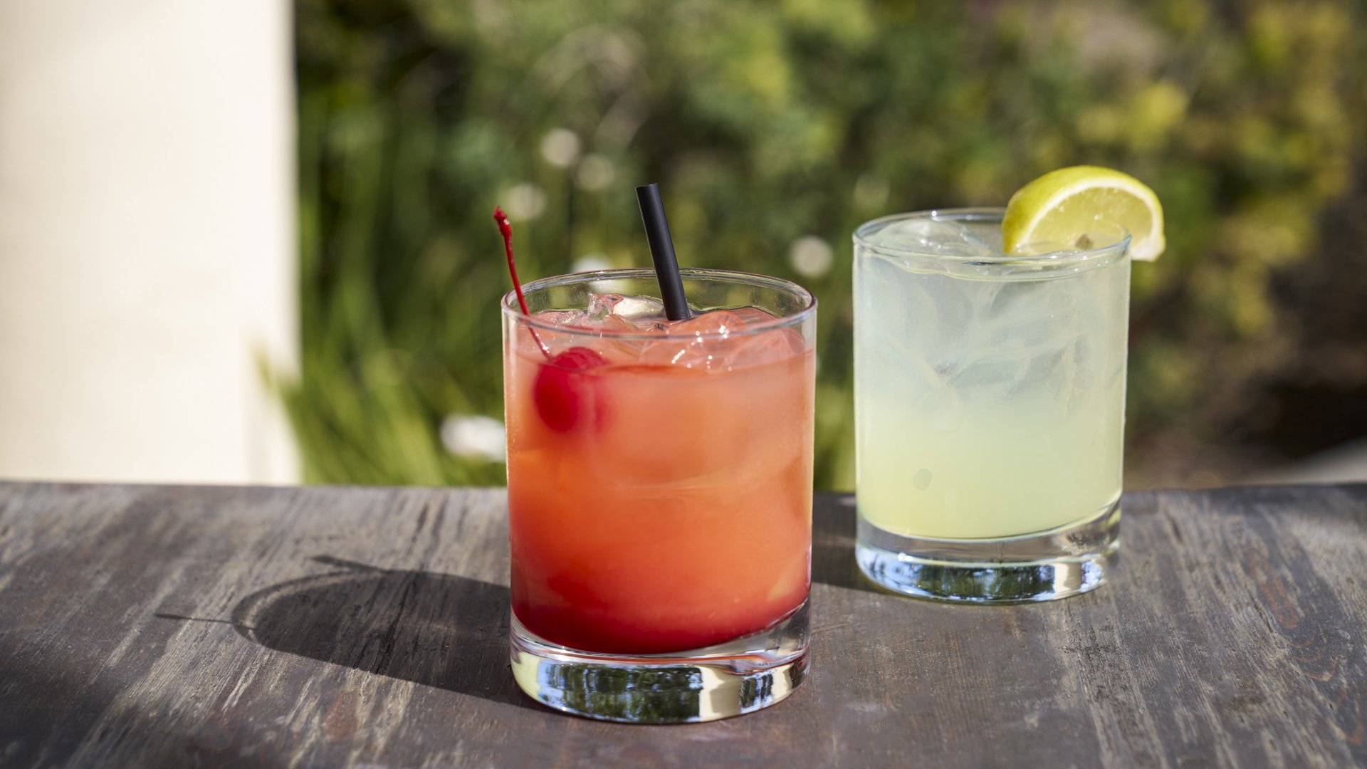 Artisanal wedding cocktails with colorful drinks, lemon garnish, and outdoor garden setting at Aliso Viejo by Wedgewood Weddings venue California