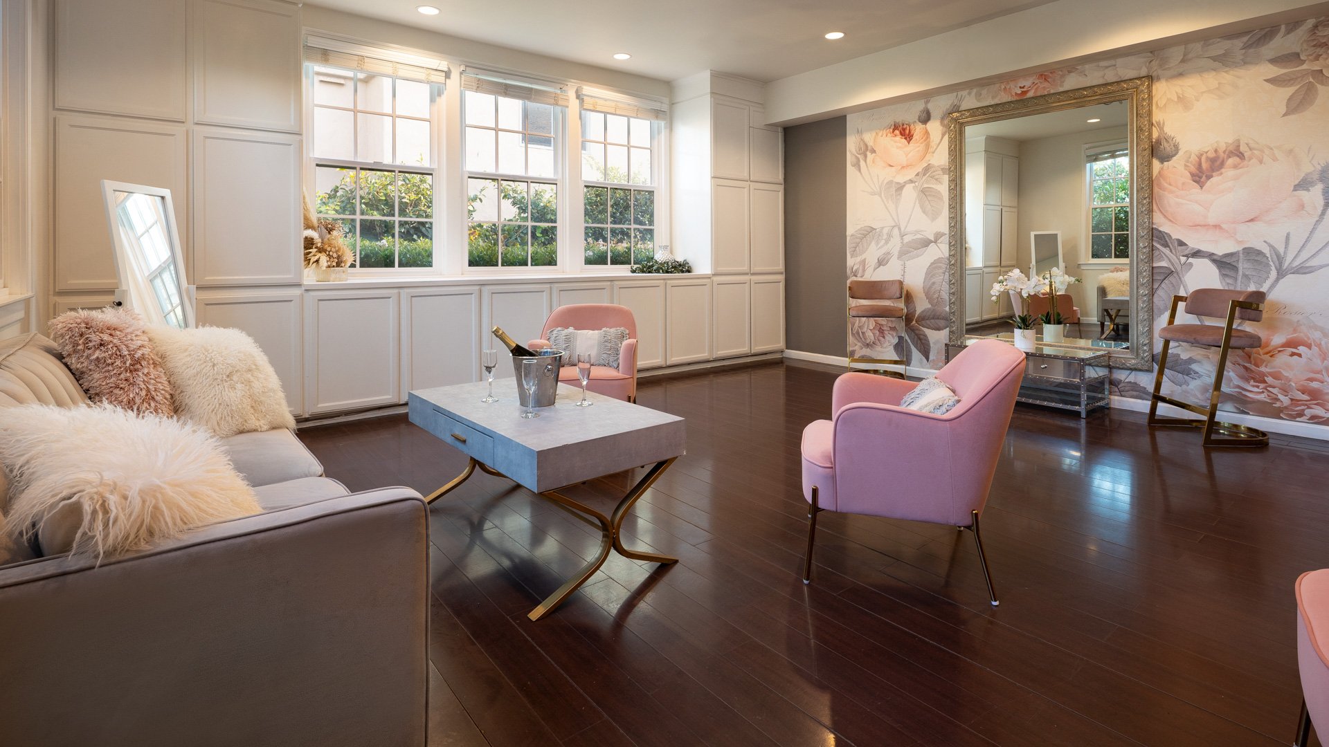 Elegant Wedding Suite at Cuvier Club by Wedgewood Weddings featuring blush pink velvet chairs, floral wallpaper, champagne service, custom millwork, and natural light in La Jolla