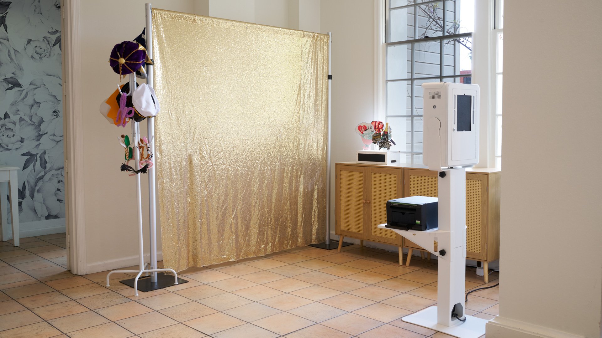 Fun wedding photo booth area at Cuvier Club by Wedgewood Weddings featuring gold sequin backdrop, prop station, and instant photo printing for guest entertainment in La Jolla