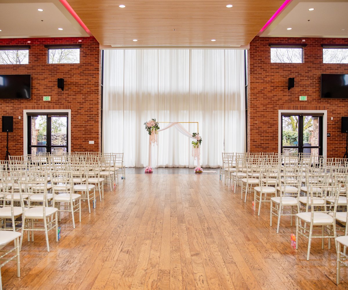 Indoor ceremony with elegant white drapery and gold wedding arch - Evergreen Springs by Wedgewood Weddings - 7