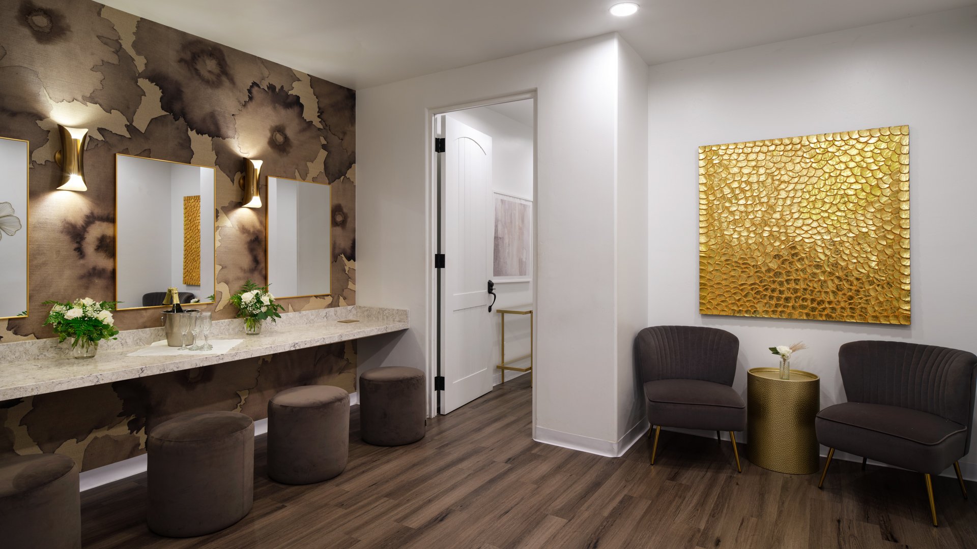 Sophisticated wedding suite at Fallbrook Estate by Wedgewood Weddings featuring modern vanity area, gold accent wall, comfortable seating, and premium amenities for wedding preparation