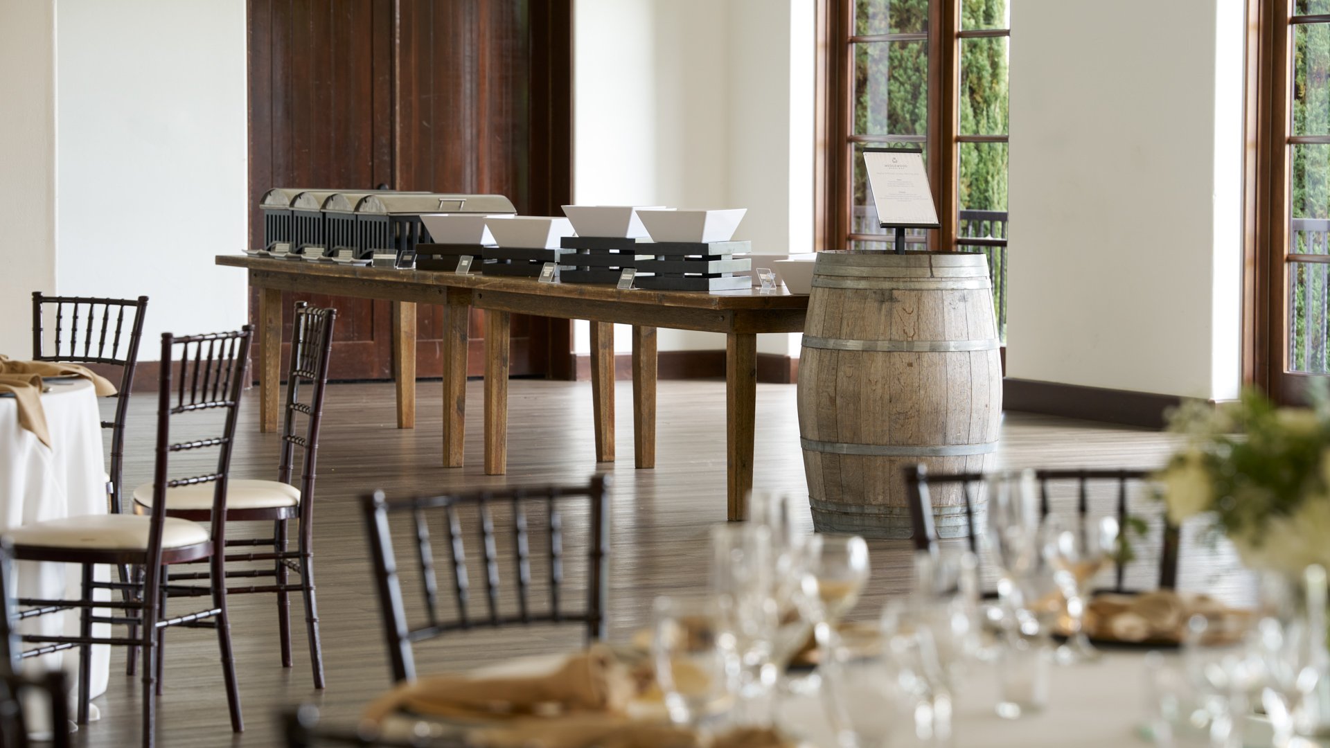 Rustic wedding catering station at Fallbrook Estate by Wedgewood Weddings featuring wooden serving tables, wine barrel accent, warming trays and elegant presentation in Spanish colonial venue