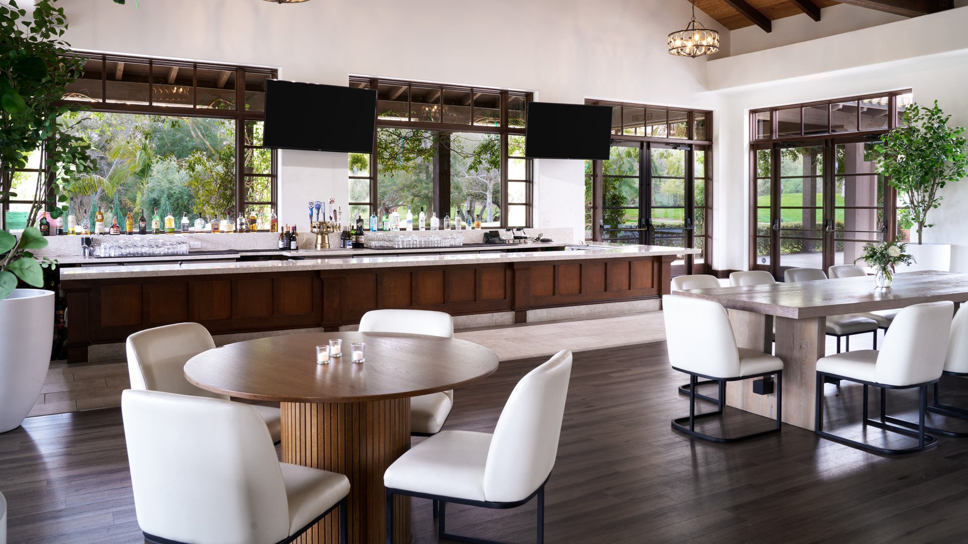 Modern wedding reception bar at Fallbrook Estate by Wedgewood Weddings featuring full service bar, contemporary seating, exposed beam ceiling and floor-to-ceiling windows with garden views