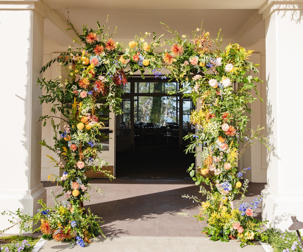 Floral wedding arch with vibrant flowers in San Francisco - Golden Gate Club at the Presidio - Wedgewood Weddings - 1
