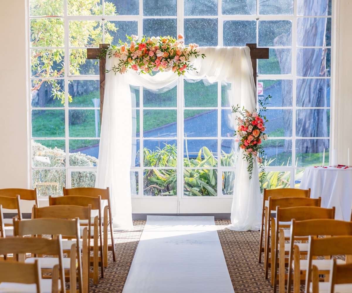 Hawthorn Room indoor wedding ceremony with pink, blush, and white floral arrangements - Golden Gate Club at the Presidio - Wedgewood Weddings - 1