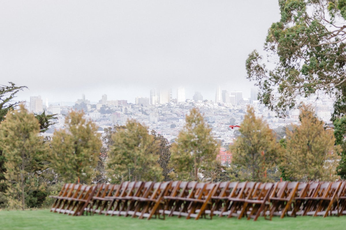 Ceremony arch sitting in front of Golden Gate Bridge in the background - Log Cabin at the Presidio - Wedgewood Weddings - 1