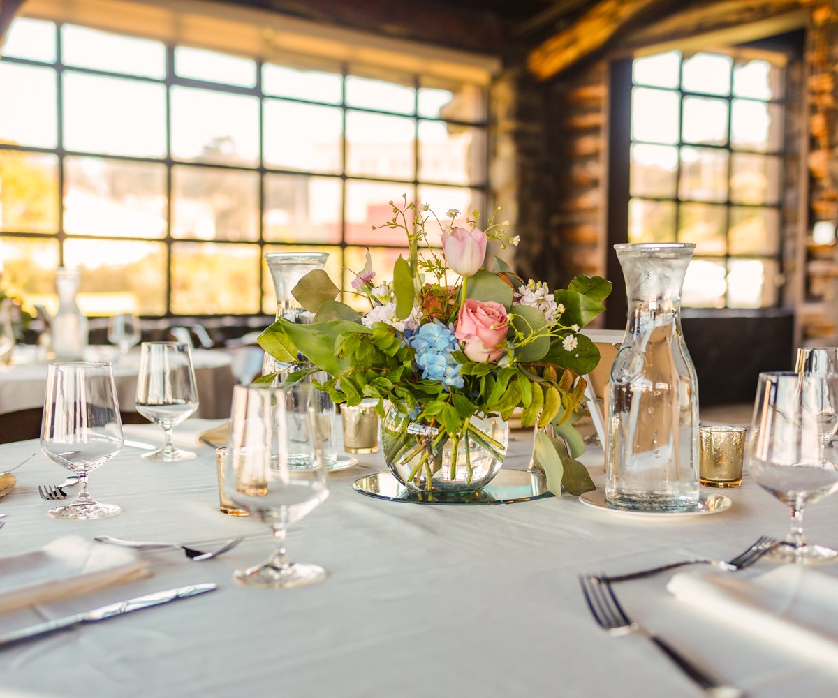 Charming tablescape with pink roses, tulips, and blue gardenias on white linens - Log Cabin at the Presidio - Wedgewood Weddings - 1