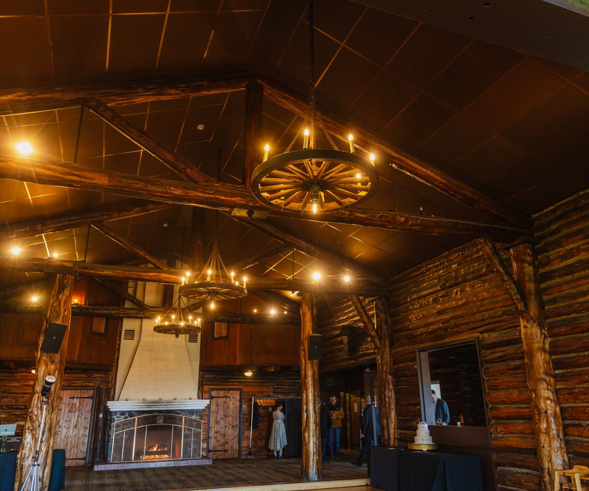 Grand hall at the historic Log Cabin with rustic wheel barrel chandeliers - Log Cabin at the Presidio - Wedgewood Weddings - 2
