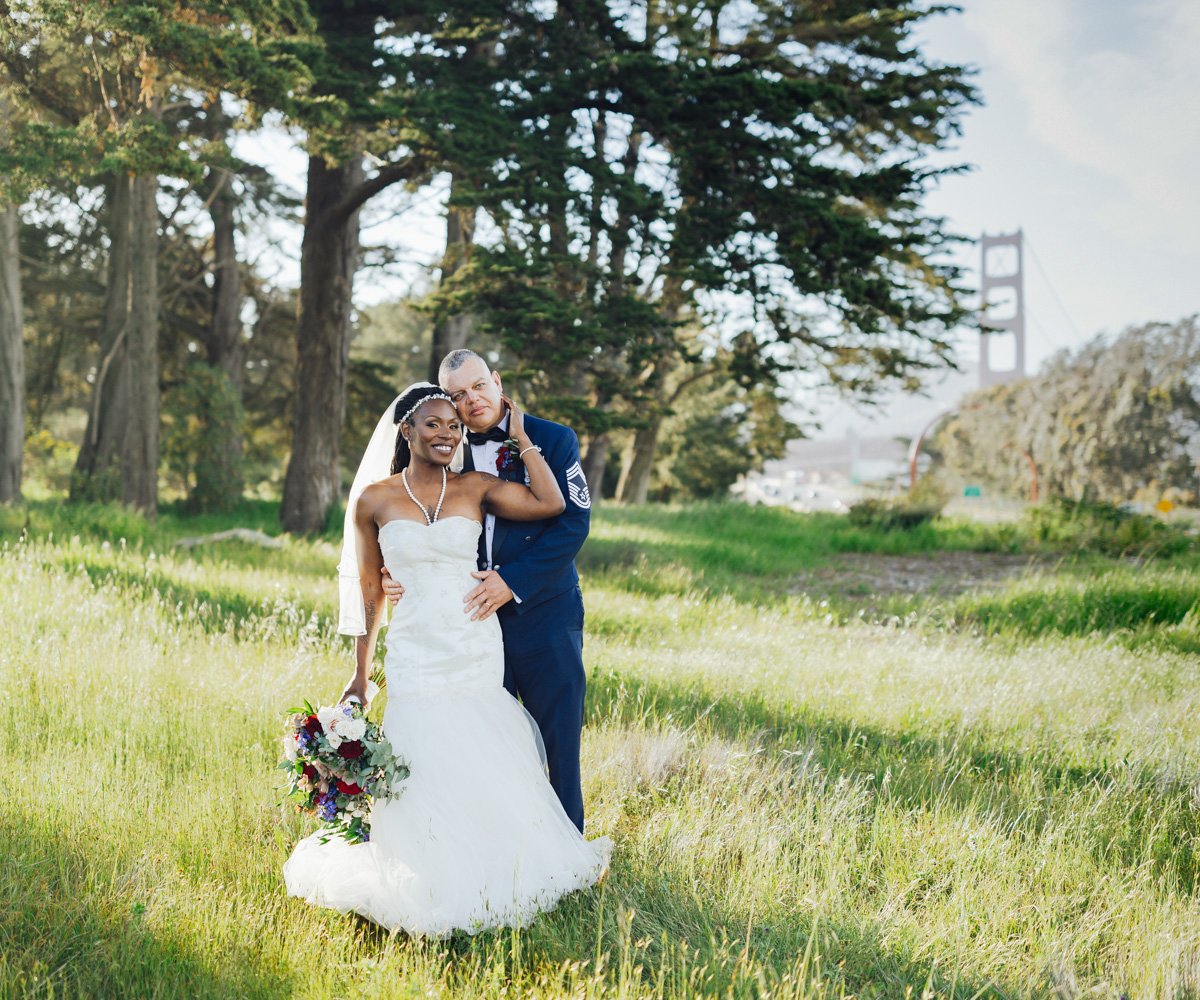 Newlywed couple posing in front of the Golden Gate Bridge - Log Cabin at the Presidio - Wedgewood Weddings - 1