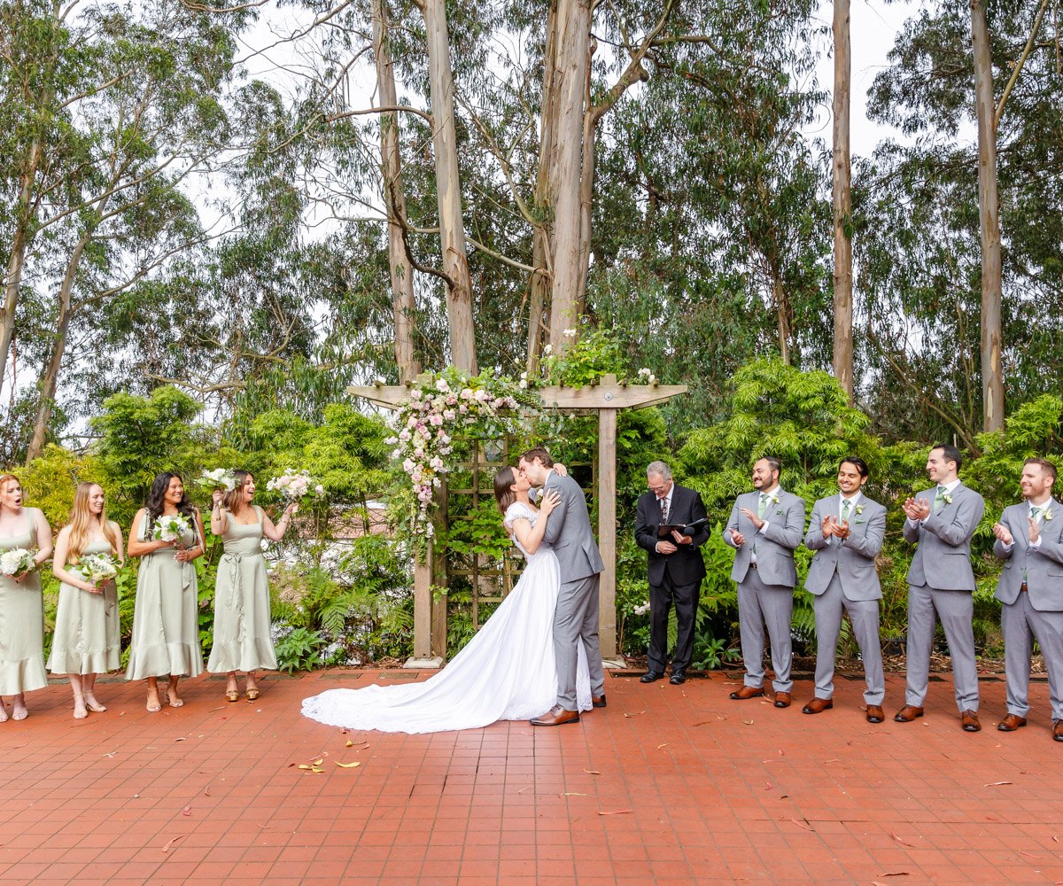 Bride and groom sharing first kiss - Presidio Chapel at the Golden Gate Club - Wedgewood Weddings