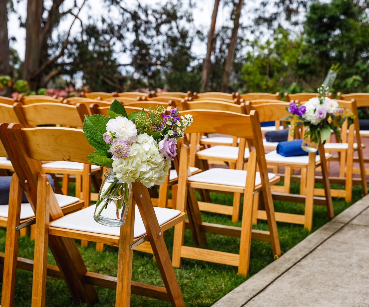 Floral decor for aisle for outdoor wedding ceremony with purple and pink flowers - Presidio Chapel at the Golden Gate Club - Wedgewood Weddings