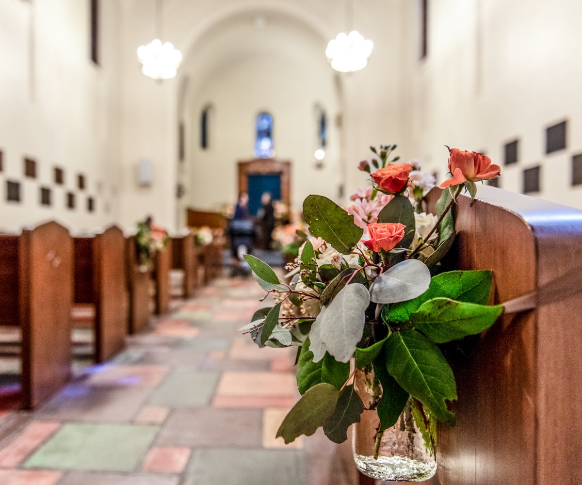 Floral decorations on church pew in historic chapel - Presidio Chapel at the Golden Gate Club - Wedgewood Weddings-1