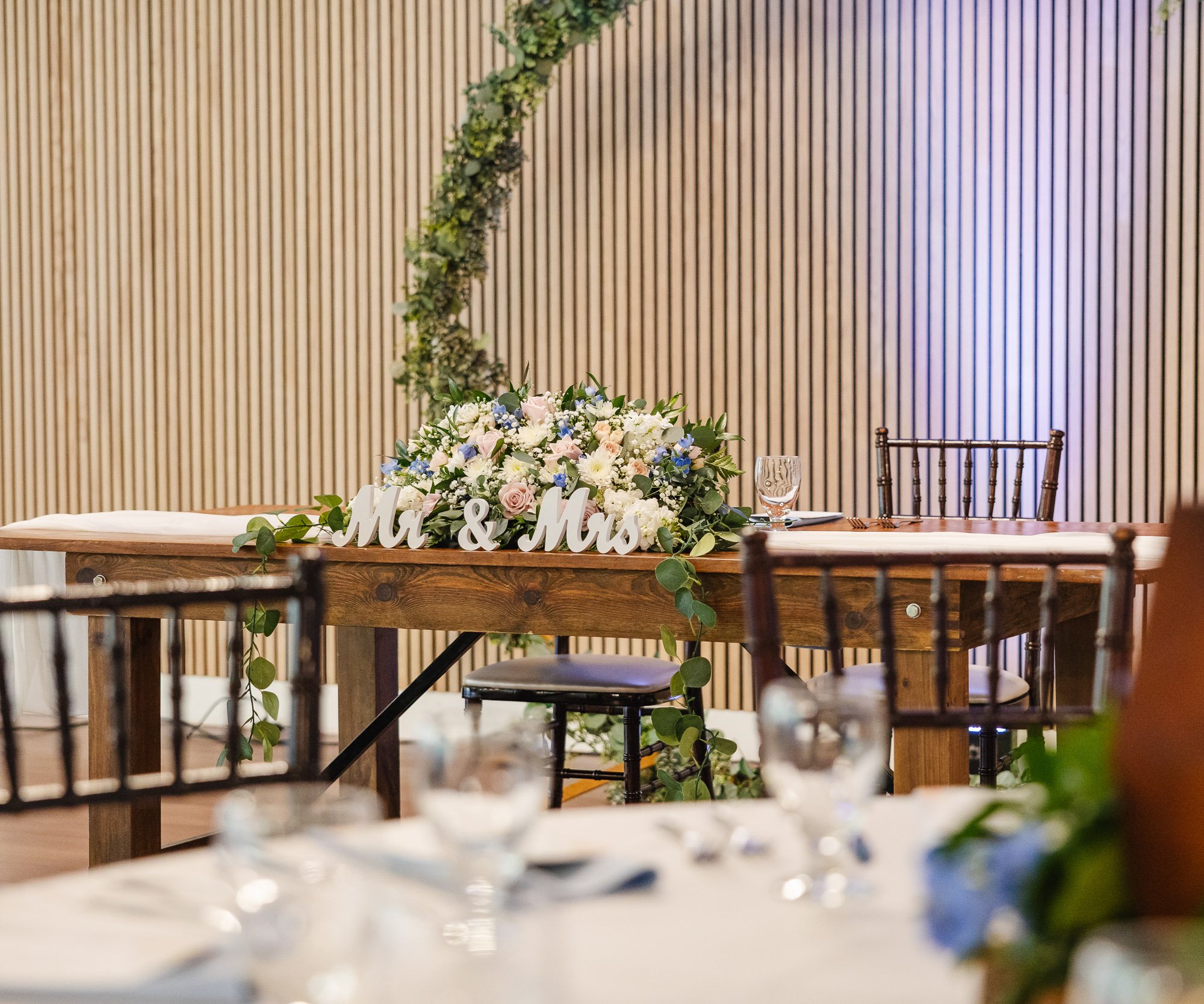 Sweetheart table detail at Redwood Canyon. Napa tables are decorated with white runners and are complemented by chivari chairs.
