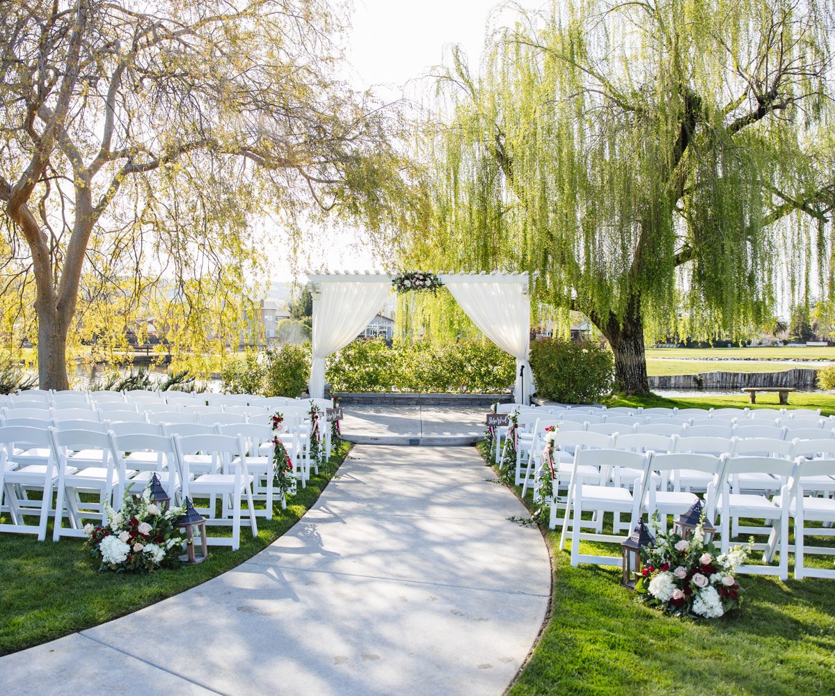Outdoor wedding ceremony with cascading willow tress and lush greenery - San Ramon Waters by Wedgewood Weddings