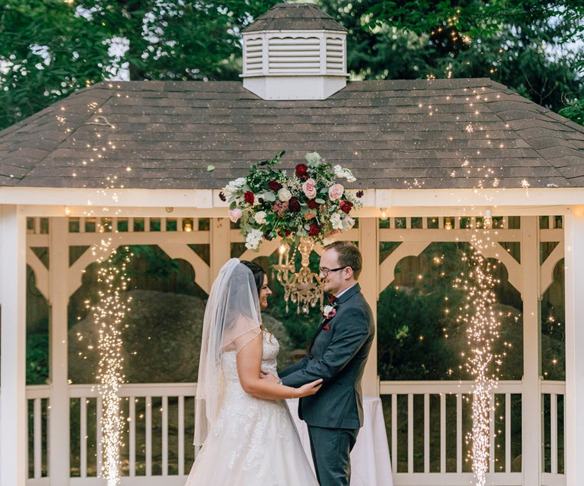 Bride and groom smiling after saying -I do- during their wedding ceremony - Tapestry House by Wedgewood Weddings