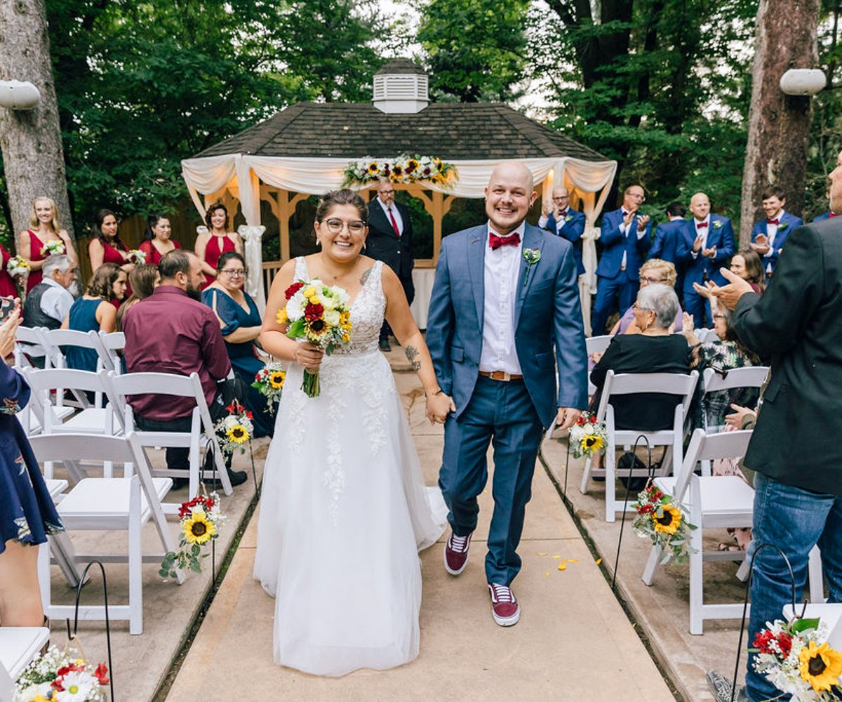 Bride and groom walking down the aisle after saying -I do- - Tapestry House by Wedgewood Weddings