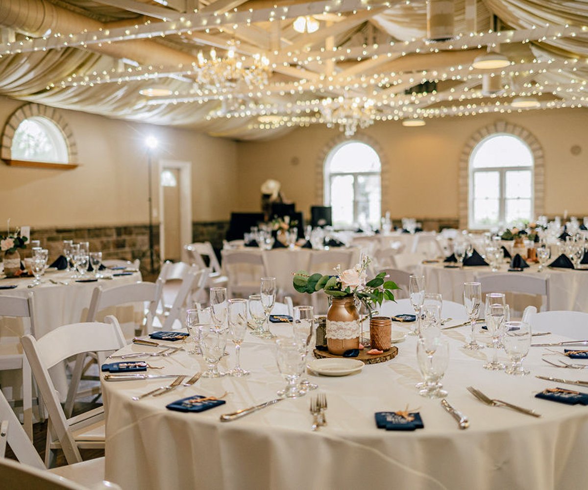 Reception hall with twinkle lights and white linens - Tapestry House by Wedgewood Weddings